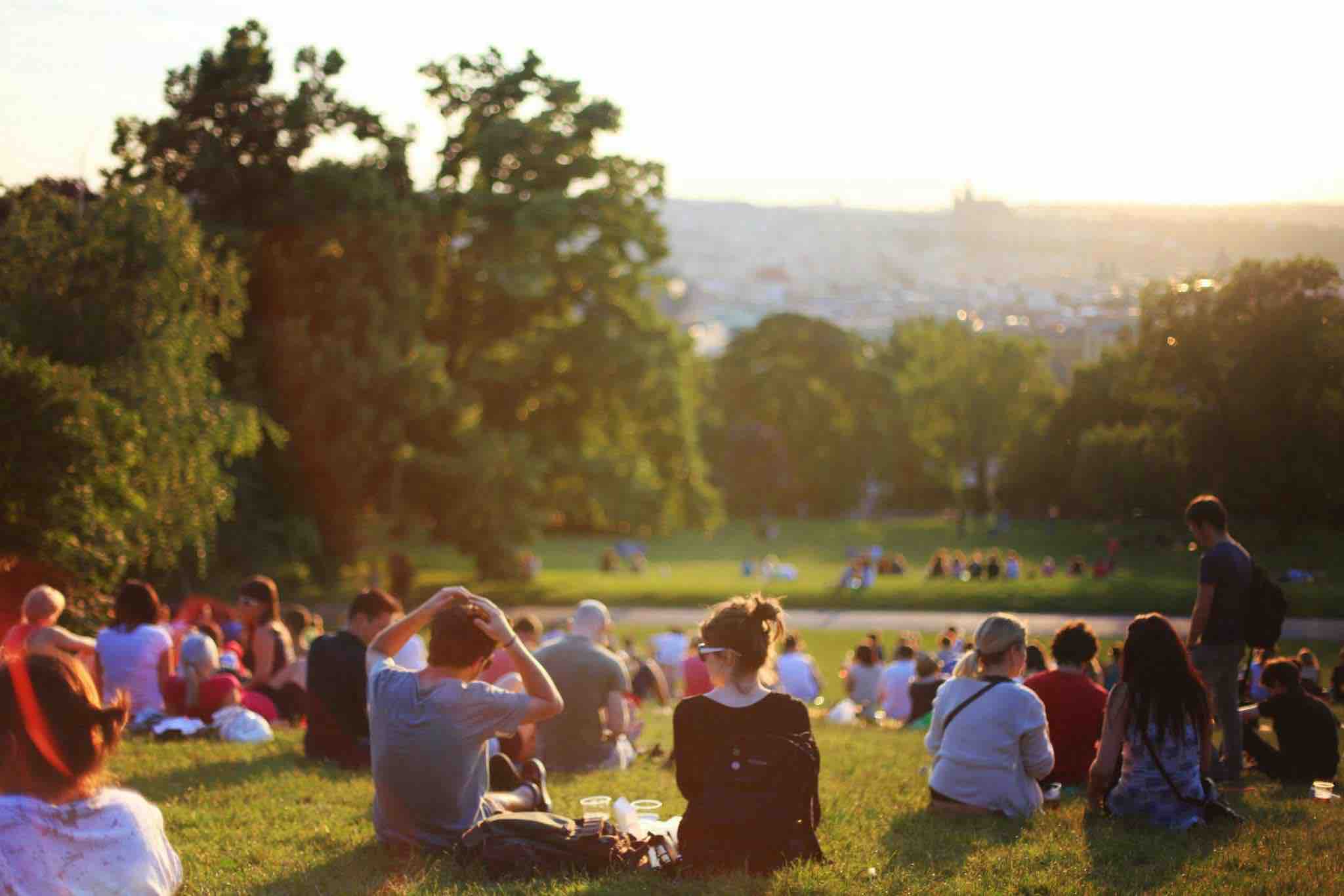 group of people sitting in a park together